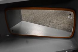 A 20th-century Danish-style teak wood framed wall mirror, of rectangular form with rounded