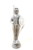 A decorative early 20th-century metal tabletop medieval knight-style figure, having an articulated