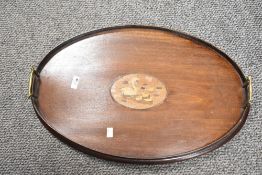 An Edwardian inlaid mahogany serving tray, of oval form, having a central inlaid marquetry design of