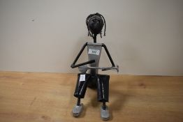 A contemporary hand crafted recycled metal sculpture of a musician, unmarked, 25cm, condition is