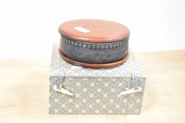 A modern Chinese Duan type inkstone, of circular form with carved recess and repeating borders, sold