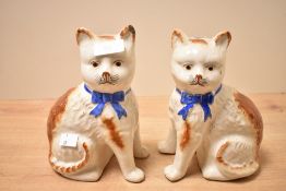 Two sweet 19th-century Staffordshire pottery mantel cat figurines, featuring hand-painted royal blue