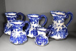Five early 20th-century Royal Doulton 'Oyama' graduated jugs, featuring a traditional blue and white