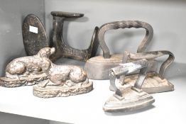 A quantity of 19th-century cast iron ware, to include a pair of flat back mantel/doorstop lying