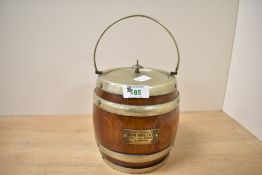 An early 20th-century oak biscuit barrel, silver-plated banded and fitted with a lidded top with