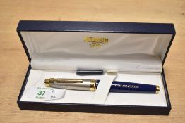 A boxed Ronson cartridge/ converter fill fountain pen in blue with brushed steel cap having gold