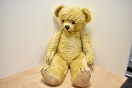A large sweet early 20th-century fully jointed teddy bear, featuring golden mohair-style fur,