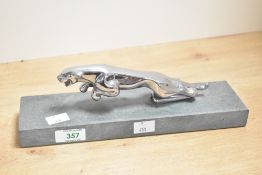 A mid to late 20th-century chrome-plated Jaguar 'Leaper' car mascot, mounted upon a hard stone