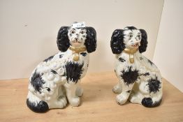 A pair of reproduction Victorian Staffordshire pottery style mantel dogs, featuring hand painted