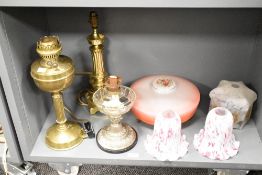 A selection of late 19th to early 20th-century lamp fittings, to include two oil lamps; a gilt-brass