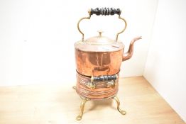 A Victorian copper and brass spirit kettle with stand and burner, featuring turned ebonised wooden