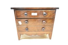 A 19th-century mahogany miniature chest of tabletop drawers, presumed apprentice piece, featuring