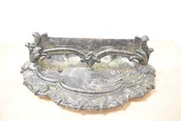 A large 19th-century cast iron boot scraper, of ornate foliate form, having a shaped scraper blade