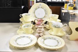 A selection of 20th-century Aynsley bone china part tea set, featuring a soft yellow palette of