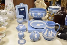 A selection of 20th-century Wedgwood blue jasperware, to feature a small jug; a photoframe; a
