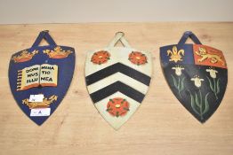 Three early 20th-century metal heraldic shields, to feature the hand painted coat of arms of Eton