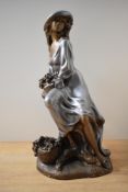 A large Art Deco style patinated metal figurine, similar to work of Alice Heath, depicting a lady