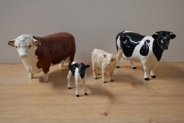 A group of four Beswick pottery cattle studies comprising Hereford Bull model number 949 designed by
