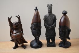 A pair of traditional wooden carved tribal busts sold together with a carved laughing Buddha and a