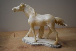 A hand-carved onyx stone stallion study on a raised marble style base, measures 17cm tall, having