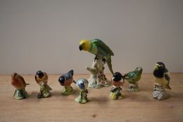 A group of eight Beswick Pottery bird studies to include 'Parakeet' model number 930 designed by