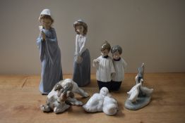 Six Lladro and Nao by Lladro porcelain figures and studies including 'Playful Puppy' and 'Girl