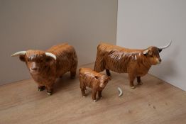 A Beswick Pottery Highland cattle trio comprising Highland Bull model number 2008, Highland Cow