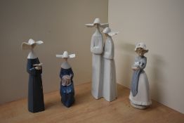 A group of four Lladro and Nao by Lladro porcelain figurines comprising 'Prayerful Moment' model