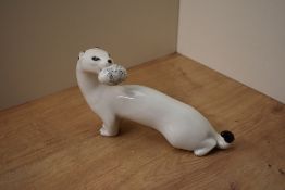 A USSR Lomonosov porcelain study of a white ermime holding a speckled egg in it's mouth, signed to