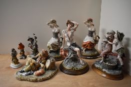 A group of six Capodimonte style figures/figurines depicting fruit pickers, a tramp, farmer and