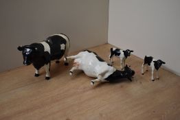 A group of four Beswick Pottery Friesian cattle comprising Friesian Bull CH. 'Coddington Hilt Bar'