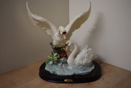 A large Juliana Collection swan group study, depicting two swans near a water feature, raised on a