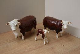 A Beswick pottery Hereford cattle family comprising Hereford Bull model number 949, Hereford Cow