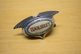A vintage Woolsey car badge