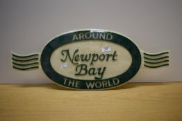 A hard Plastic Around the World Newport Bay sign