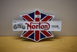 A painted cast Norton wall plaque 29.5cm wide