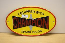 An Equipped with Champion Spark Plugs painted cast wall plaque