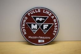A round painted cast Massey Ferguson 'Nothing Pulls Like A Massey' 23cm