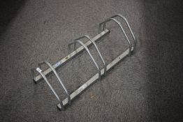 An alloy bicycle rack for three bikes can be floor or wall mounted