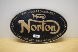 An oval cast painted wall plaque for The Unapproachable Manx Norton The worlds Best Road Holder 32cm