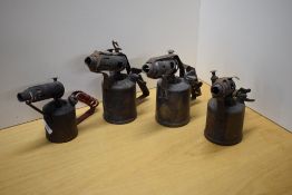 Four vintage brass blow lamps