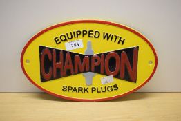A painted cast Equipped with Champion Spark Plugs oval wall plaque