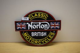 A painted Classic Norton British Motorcycles cast wall plaque