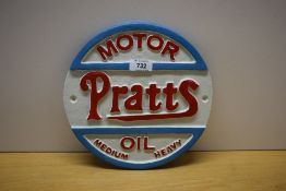 A circular painted cast Pratts Motor Oil Medium Heavy wall plaque