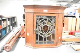 Thought to be Victorian Arts and Crafts-style oak with leaded glass corner cupboard, having a soft