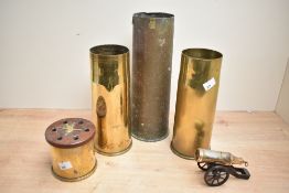 Three 20th-century brass shell casings, having been re-purposed into decorative vases, a petrol