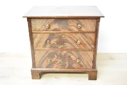 A 20th-century hardwood miniature chest of tabletop drawers, presumed apprentice piece, featuring