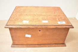 A wooden chest, containing an assortment of costume jewellery, including statement pieces, beaded