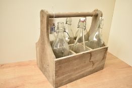 A contemporary vintage-style Lakeland wooden crate containing six glass swing-top bottles, 36cm x