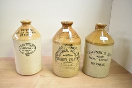 Three 19th/20th-century stoneware flagon jugs, featuring a two-toned design with black